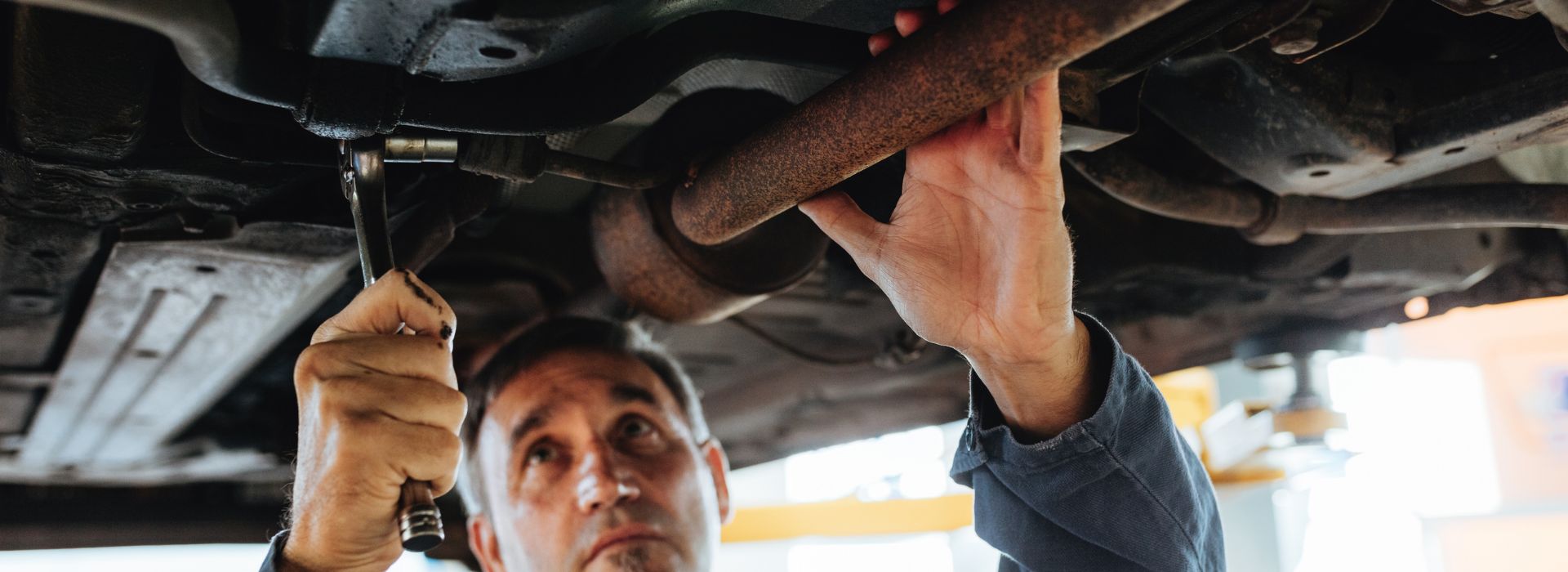 Mechanic working underneath a car